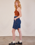 Side view of Carpenter Shorts in Dark Wash and burnt terracotta Cropped Tank on Margaret