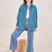 Hana is wearing Oversize Overshirt in Marine Blue, vintage off-white Cropped Tank Top and light wash Sailor Jeans