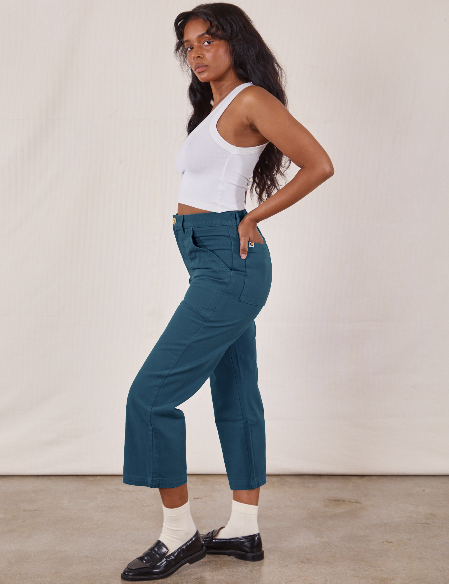 Side view of Petite Work Pants in Lagoon and vintage tee off-white Cropped Tank