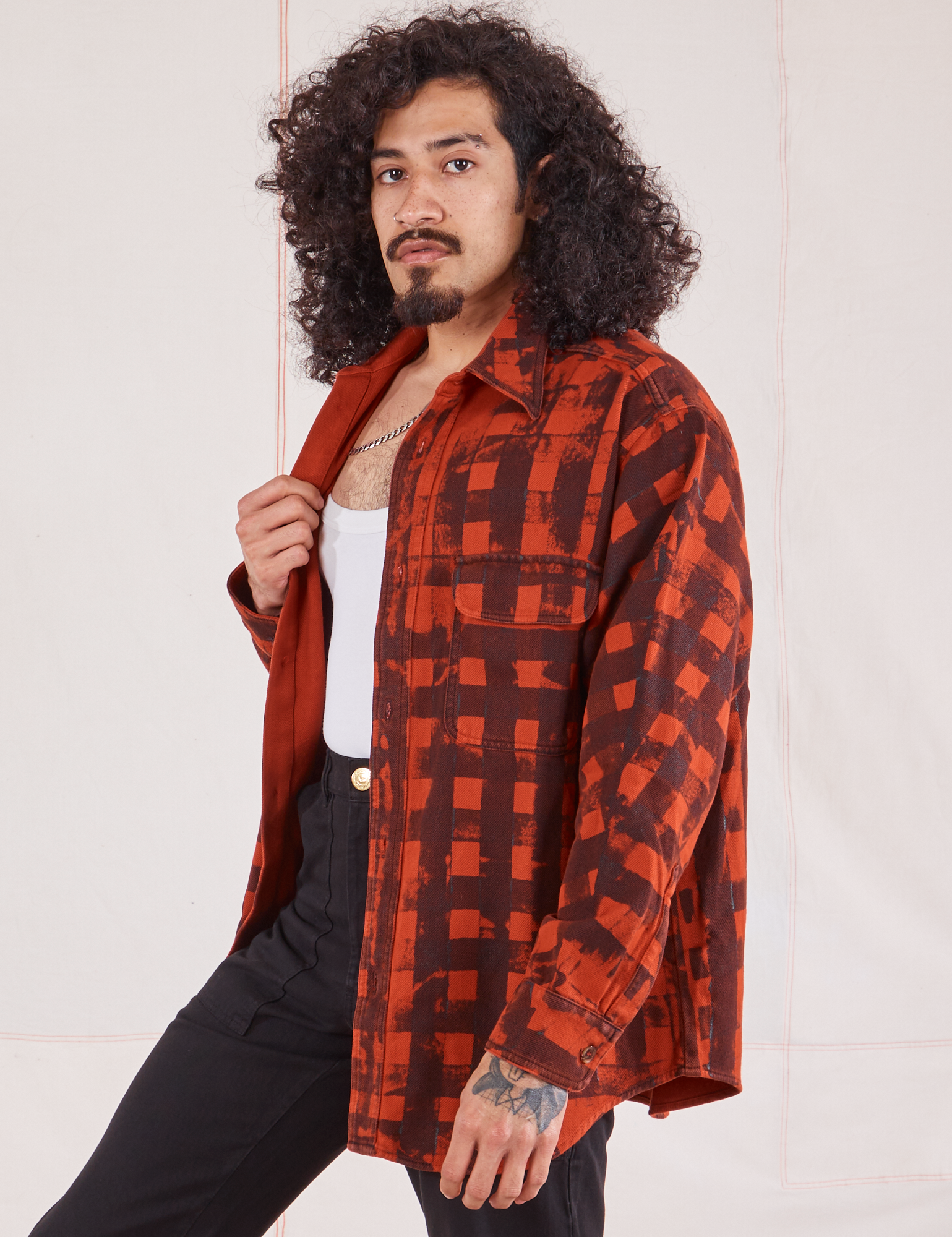 Angled view of Plaid Flannel Overshirt in Paprika on Jesse