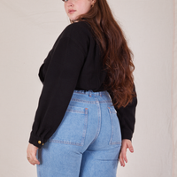 Back view of Ricky Jacket in Basic Black and light wash Sailor Jeans worn by Sydney