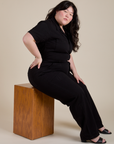 Ashley is wearing Short Sleeve Jumpsuit in Basic Black