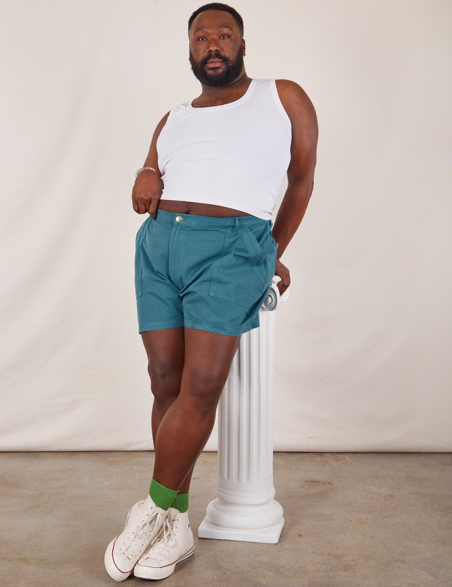 Elijah is wearing Classic Work Shorts in Marine Blue and Tank Top in vintage tee off-white