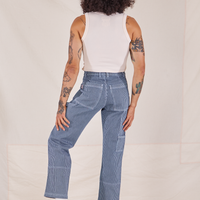 Back view of Carpenter Jeans in Railroad Stripes and vintage off-white Tank Top worn by Jesse