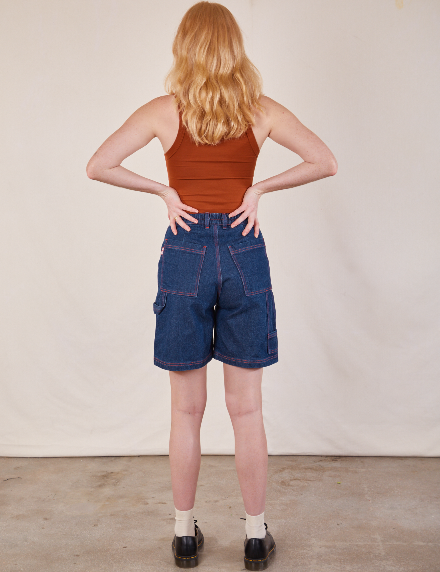 Back view of Carpenter Shorts in Dark Wash and burnt terracotta Cropped Tank on Margaret