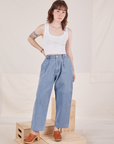 Hana is 5'3" and wearing XXS Petite Denim Trouser Jeans in Light Wash paired with Cropped Tank Top in vintage tee off-white t