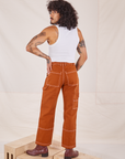 Back view of Carpenter Jeans in Burnt Terracotta and vintage off-white Cropped Tank Top on Jesse