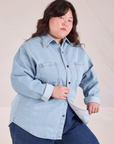 Ashley is wearing a buttoned up Denim Overshirt in Light Wash