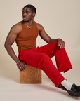 Racerback Tank in Burnt Terracotta and Work Pants in Mustang Red worn by Isaac
