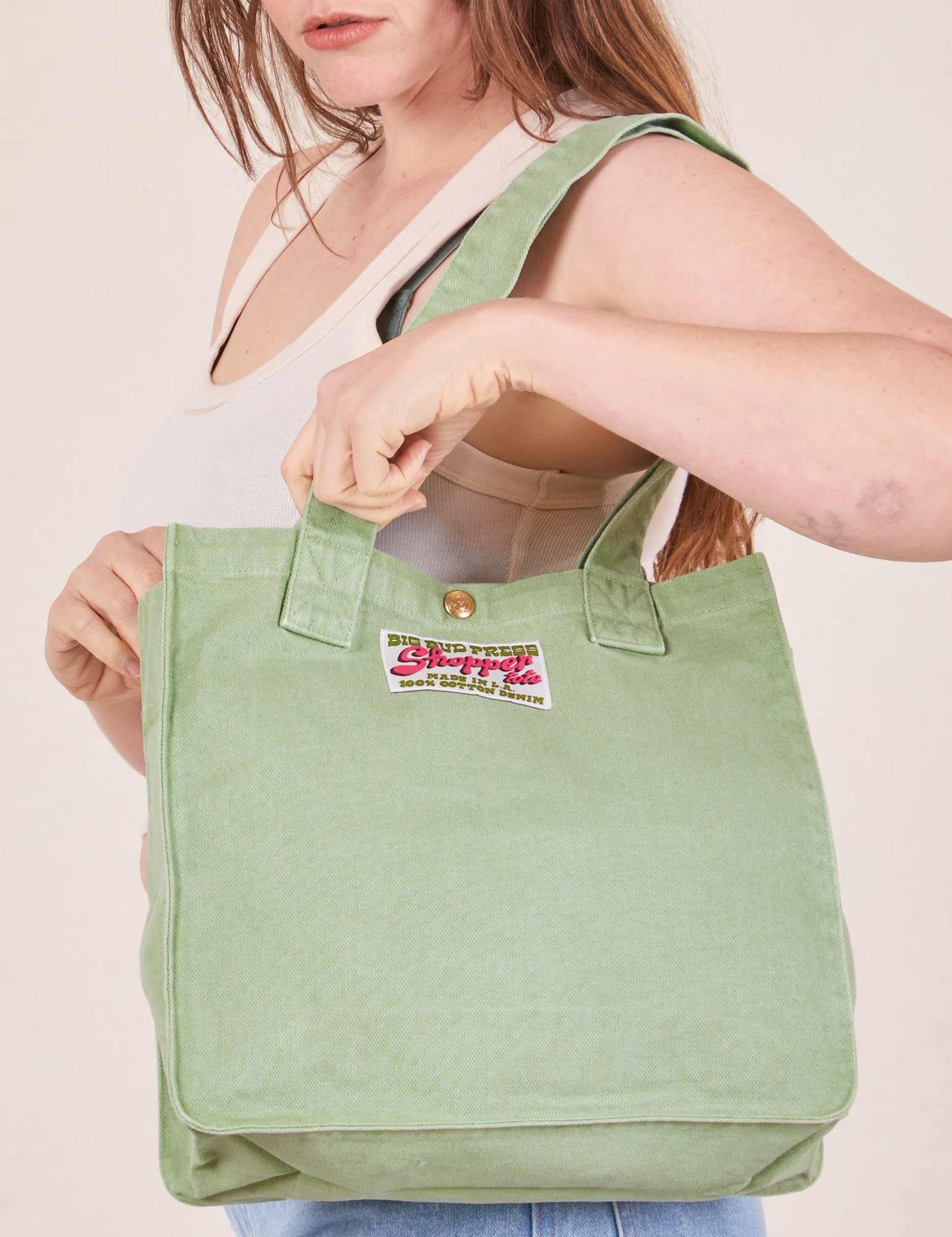 Shopper Tote Bag in Sage Green worn over shoulder on Allison