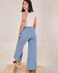 Back view of Indigo Wide Leg Trousers in Light Wash and vintage off-white Sleeveless Turtleneck on Betty