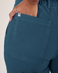 Petite Work Pants in Lagoon back pocket close up. Kandia has her hand in the back pocket.