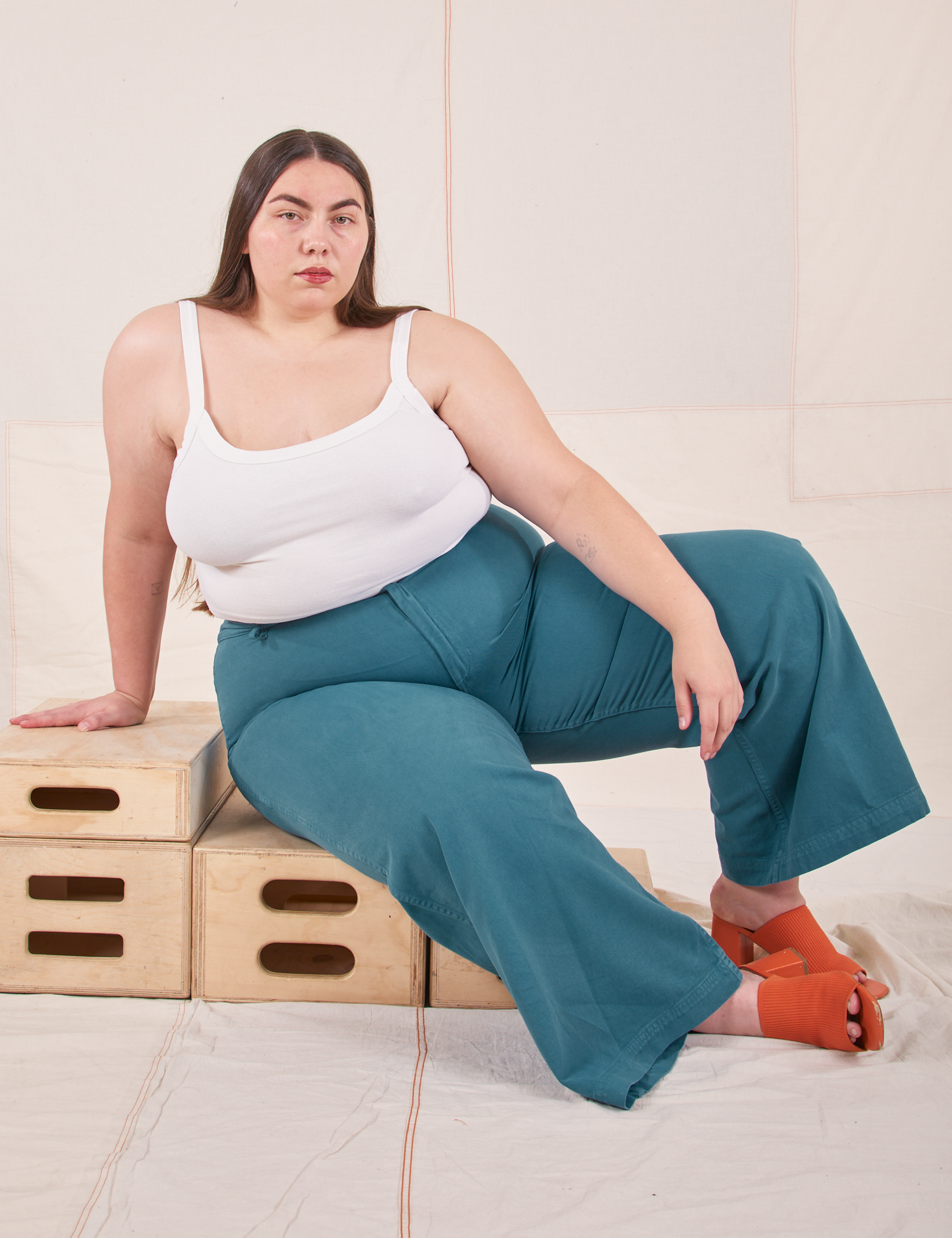 Marielena is wearing Bell Bottoms in Marine Blue and Cropped Cami in vintage tee off-white