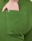Petite Pencil Pants in Lawn Green back pocket close up. Ashley has her hand in the pocket.