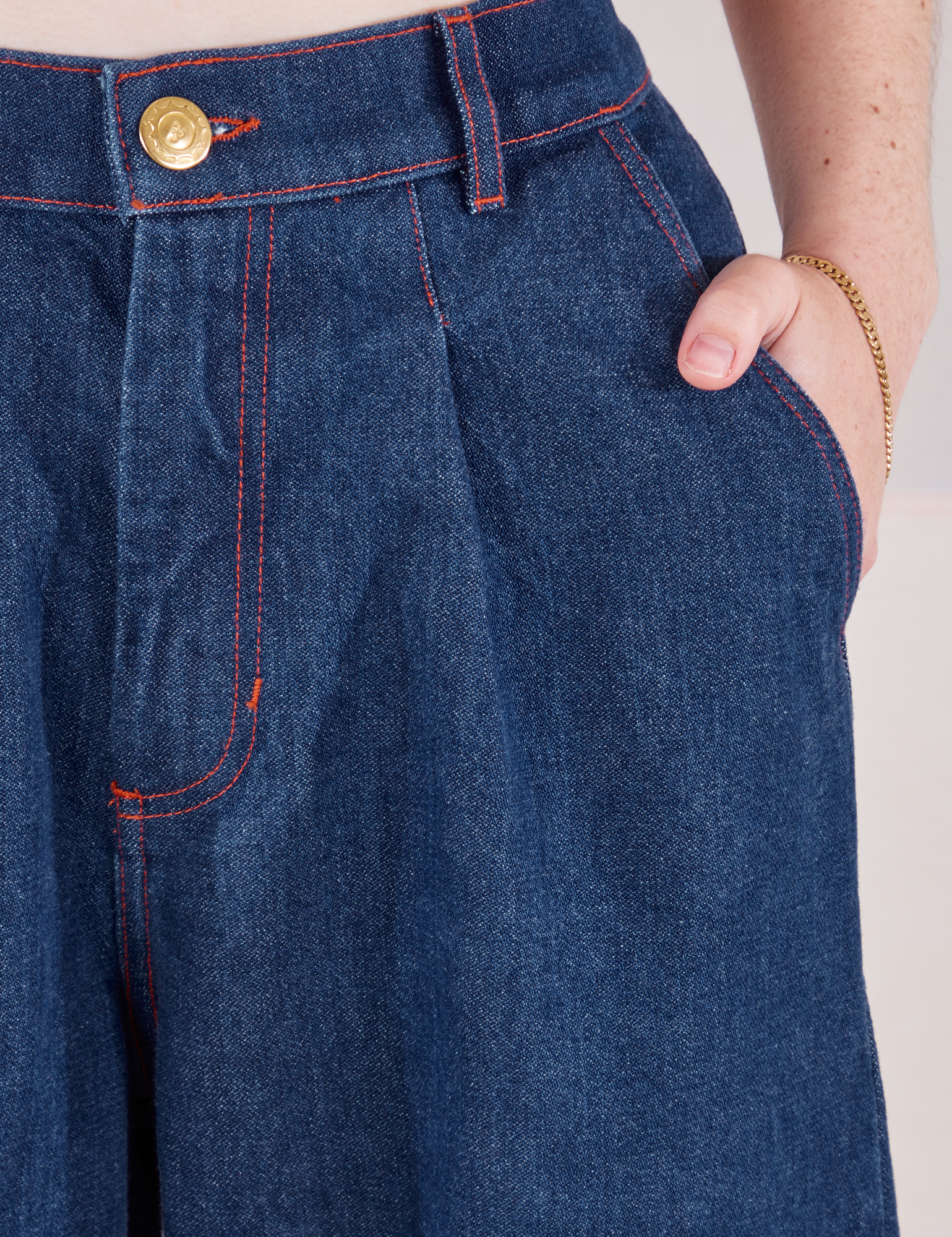 Indigo Wide Leg Trousers in Dark Wash front close up. Hana has her hand in the pocket.