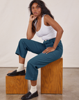Kandia is wearing Petite Work Pants in Lagoon and vintage tee off-white Cropped Tank