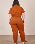 Back view of Short Sleeve Jumpsuit in Burnt Terracotta worn by Ashley