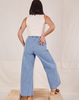 Back view of Indigo Wide Leg Trousers in Light Wash and vintage off-white Sleeveless Turtleneck on Betty