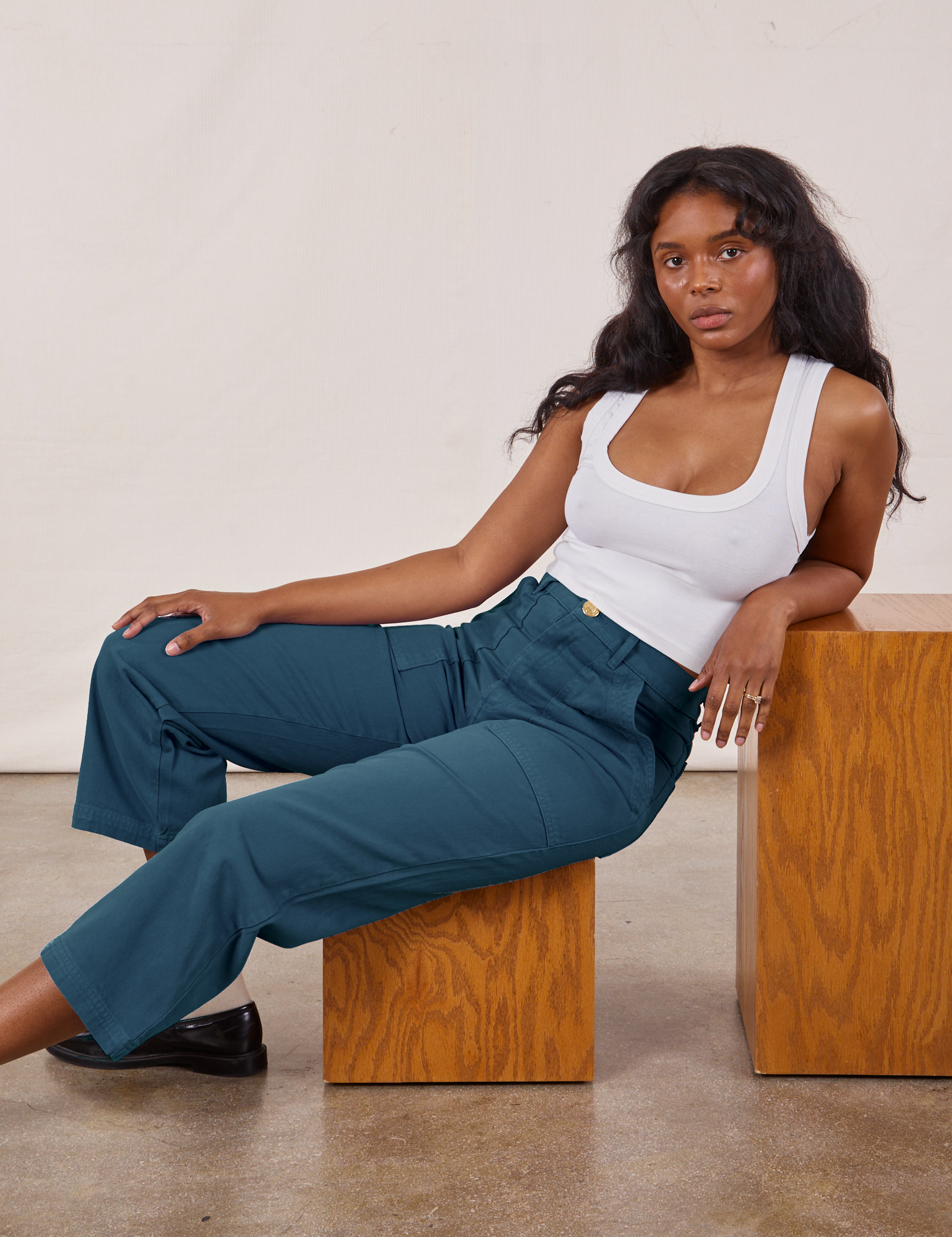 Kandia is wearing Petite Work Pants in Lagoon and vintage tee off-white Cropped Tank