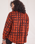 Angled back view of Plaid Flannel Overshirt in Paprika on Jesse