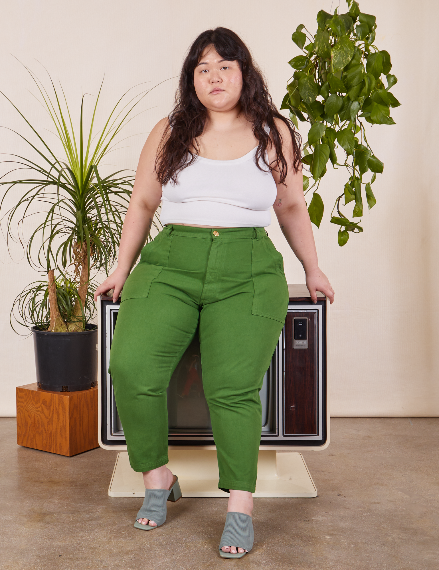 Ashley is wearing Petite Pencil Pants in Lawn Green and vintage off-white Cropped Cami