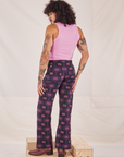 Angled back view of Western Pants in Purple Tile Jacquard and bubblegum pink Cropped Tank Top on Jesse