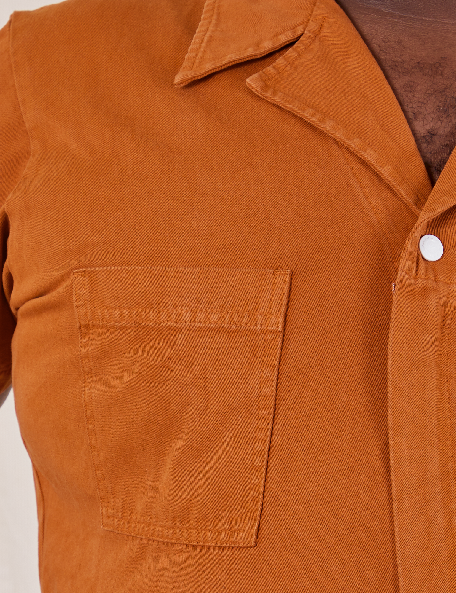 Front close up of Short Sleeve Jumpsuit in Burnt Terracotta worn by Elijah