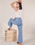Back view of Indigo Wide Leg Trousers in Light Wash and vintage off-white Sleeveless Turtleneck on Betty