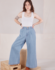 Hana is 5'3" and wearing P Petite Indigo Wide Leg Trousers in Light Wash paired with a vintage tee off-white Cropped Tank