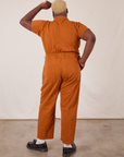 Back view of Short Sleeve Jumpsuit in Burnt Terracotta worn by Elijah
