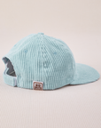 Side view of Dugout Corduroy Hat in Baby Blue. Big Bud label sewn on edge of hat.
