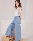 Side view of Indigo Wide Leg Petite Trousers and vintage tee off-white Cropped Tank