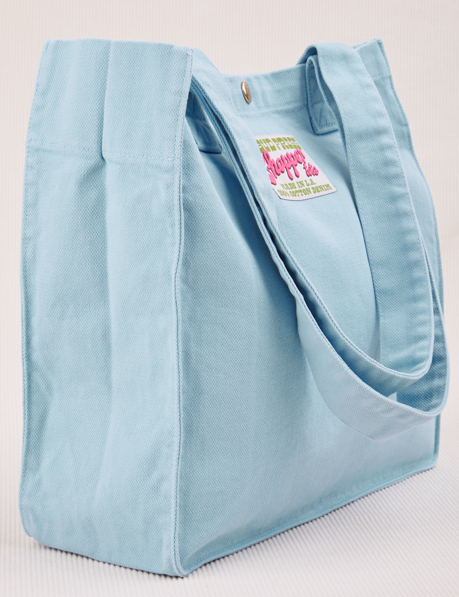Angled view of Shopper Tote Bag in Baby Blue
