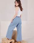 Angled back view of Indigo Wide Leg Petite Trousers and vintage tee off-white Cropped Tank worn by Hana