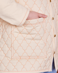 Quilted Overcoat in Vintage Off-White pocket close up with Ashley's hand in the pocket