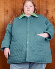 Catie is wearing a buttoned up Quilted Overcoat in Marine Blue