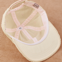 Dugout Corduroy Hat in Vintage Off-White flipped over. White satin under-bill.