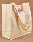 Angled view of Shopper Tote Bag in Vintage Off-White