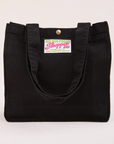 Shopper Tote Bag in Black with straps hanging down front of bag