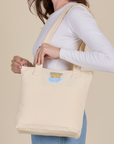 Over-Shoulder Zip Mini Tote in Vintage Tee Off-White worn on shoulder of model
