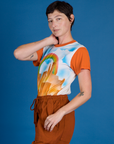 Side view of Alex in the Orange Mesa Airbrush Vintage Tee