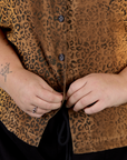 Close up on Juliet buttoning up the Leopard Pantry Button Up