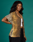 Side view of Kandia wearing the Leopard Pantry Button Up