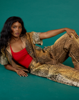 Kandia wearing the Leopard Pantry Button Up open with the Mustang Cropped Tank underneath and matching Leopard Work Pants