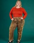 Juliet is 5’7” and wearing 2XL Leopard Work Pant with the Chili Red Long Sleeve Baby Tee