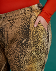 Close up of Juliet's hand in the front pocket of the Leopard Work Pant