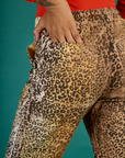 Close up of Kira's hand in the back pocket of the Leopard Work Pant