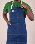 Isaac is wearing Full Indigo Denim Apron in dark wash