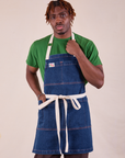 Isaac is wearing Full Indigo Denim Apron in dark wash