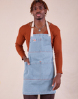 Isaac is wearing the light wash Full Indigo Denim Apron